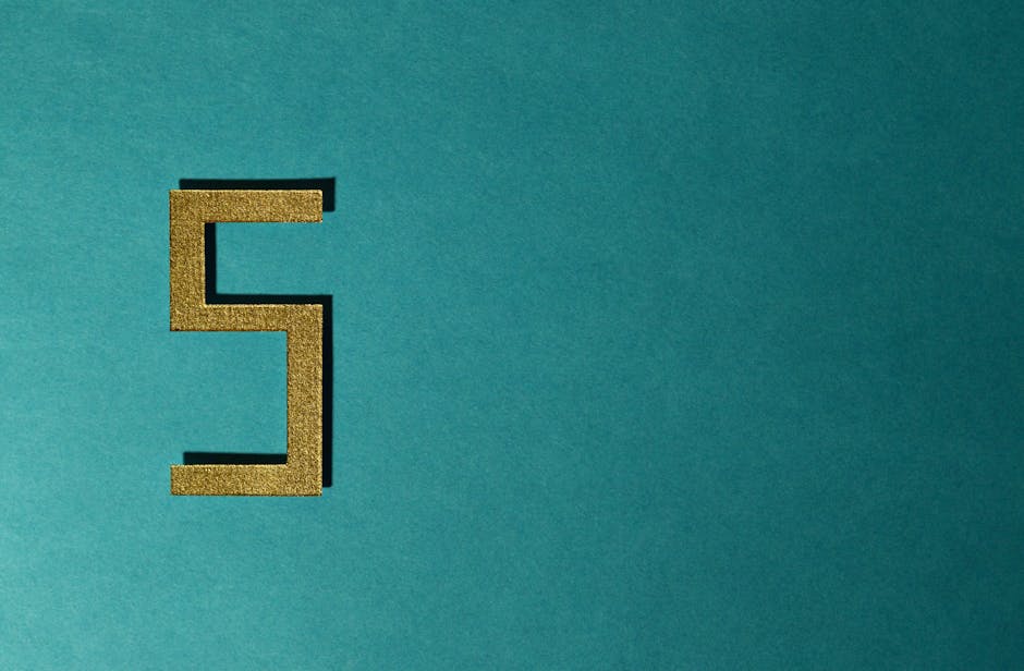 Golden number five on a teal wall representing premium financial standards